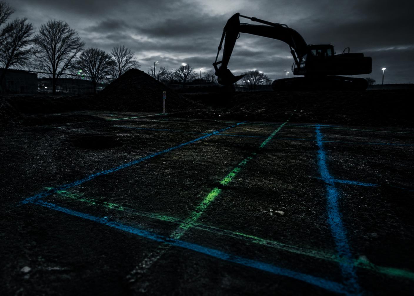 Excavation site with utility markings before digging
